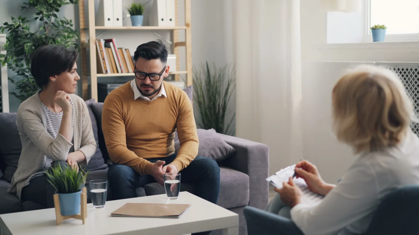 Couple sitting with a therapist during a couples therapy session